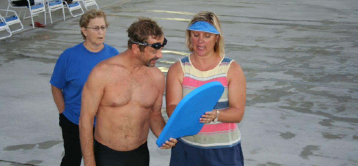 Swimmers lined up along the pool deck before a Palm Beach Masters workout