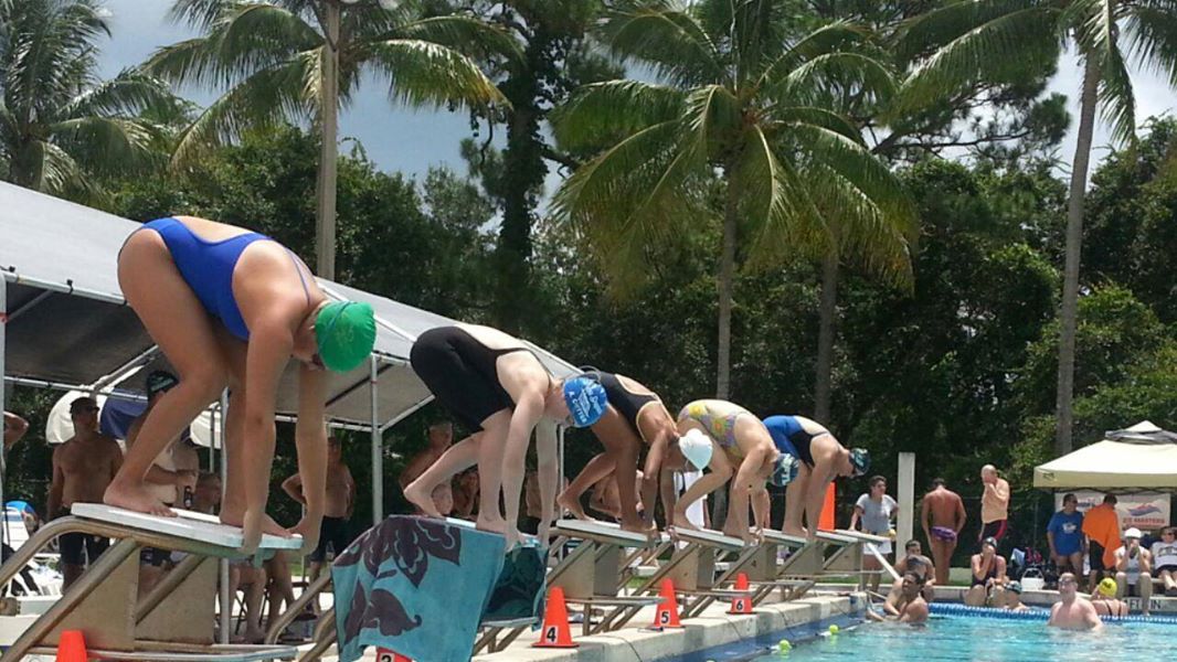 Swimmers on the starting blocks at the June Krauser Summer Splash meet